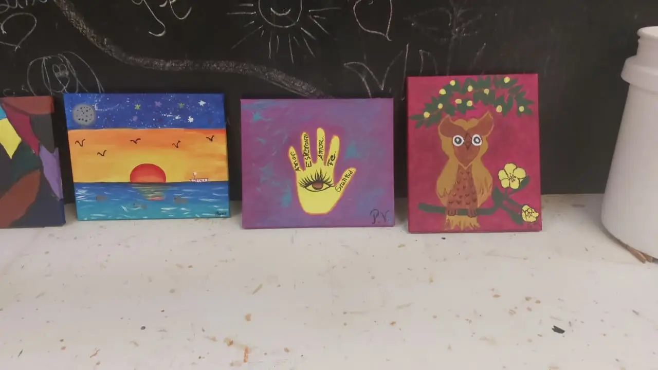 Workshop paintings against a chalkboard
